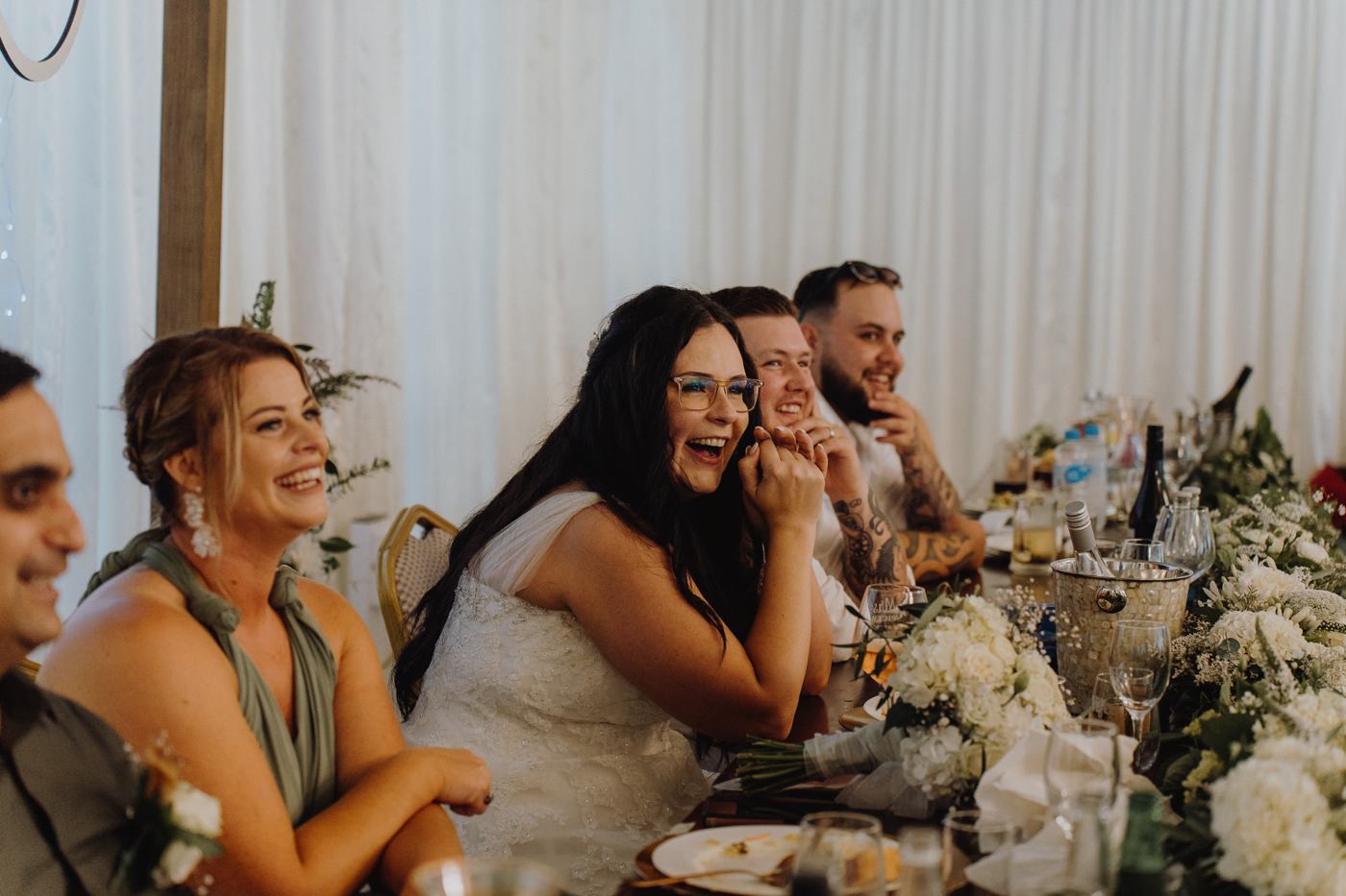 The bridal table laughing together during the speeches