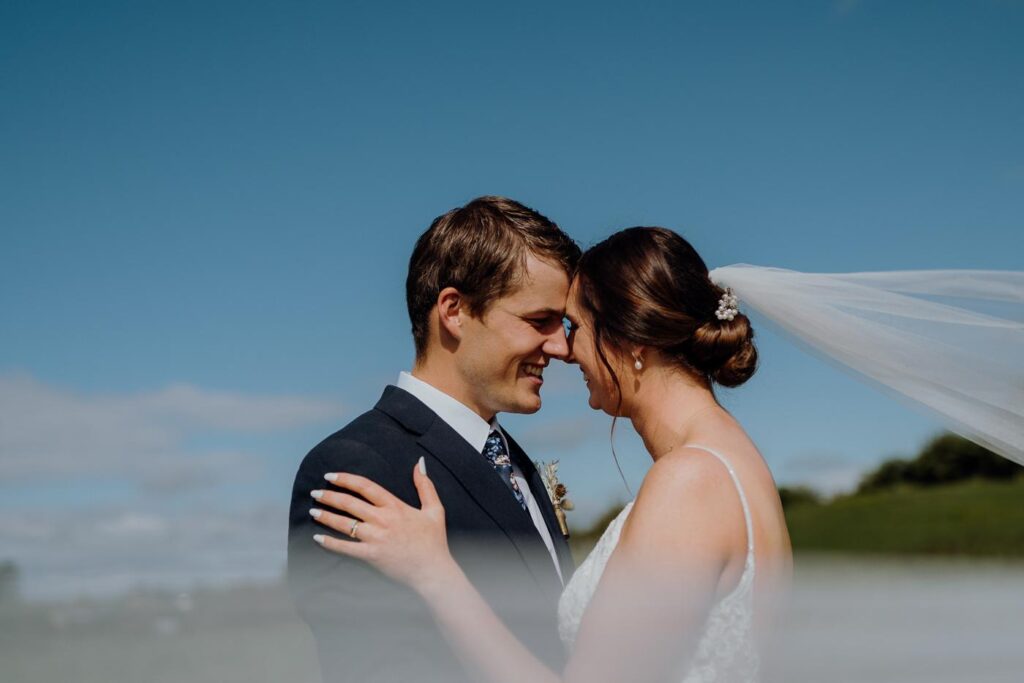 Kim and Simon on a hilltop under a big blue sky