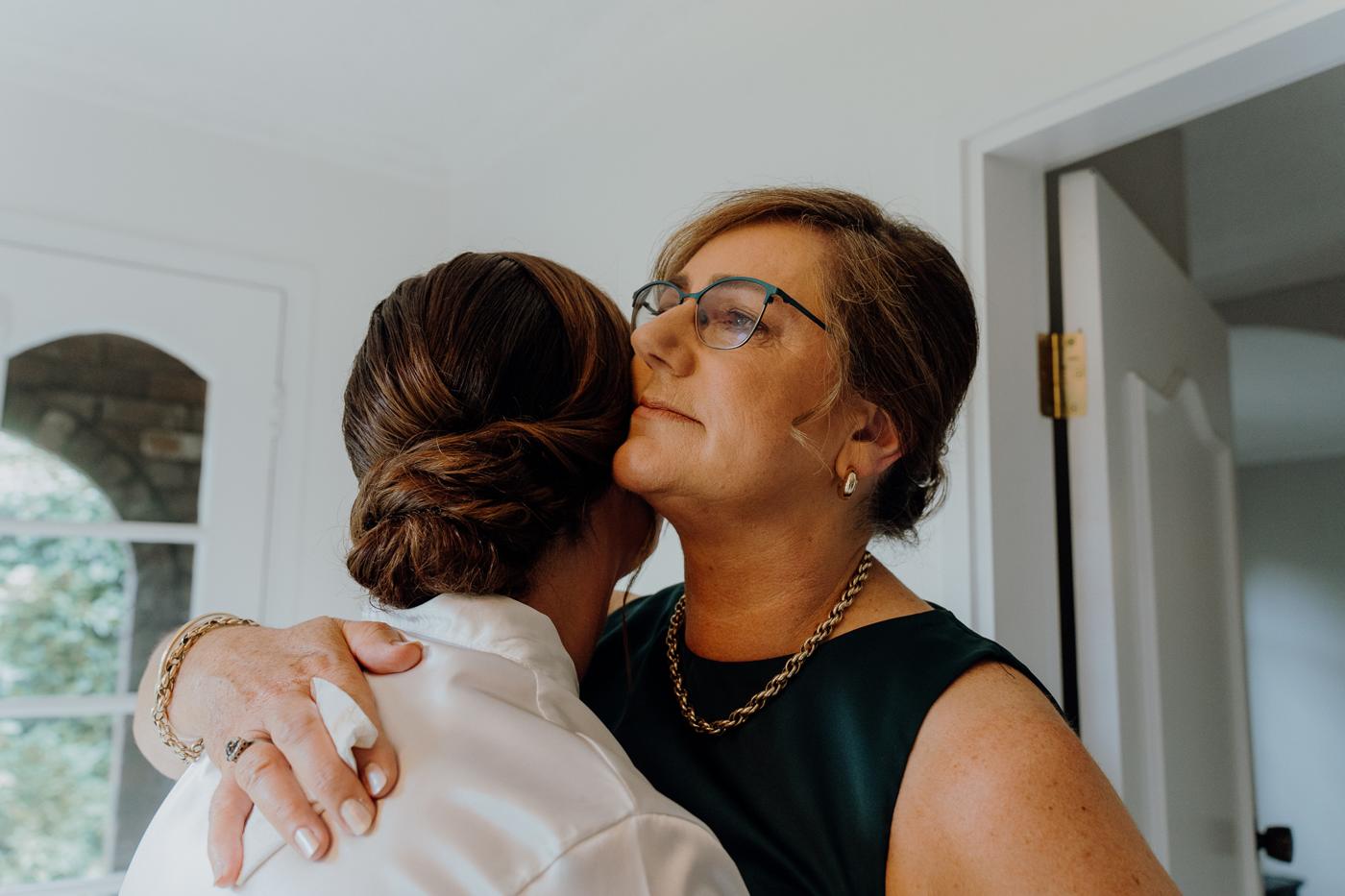 A mother embracing her daughter, the bride