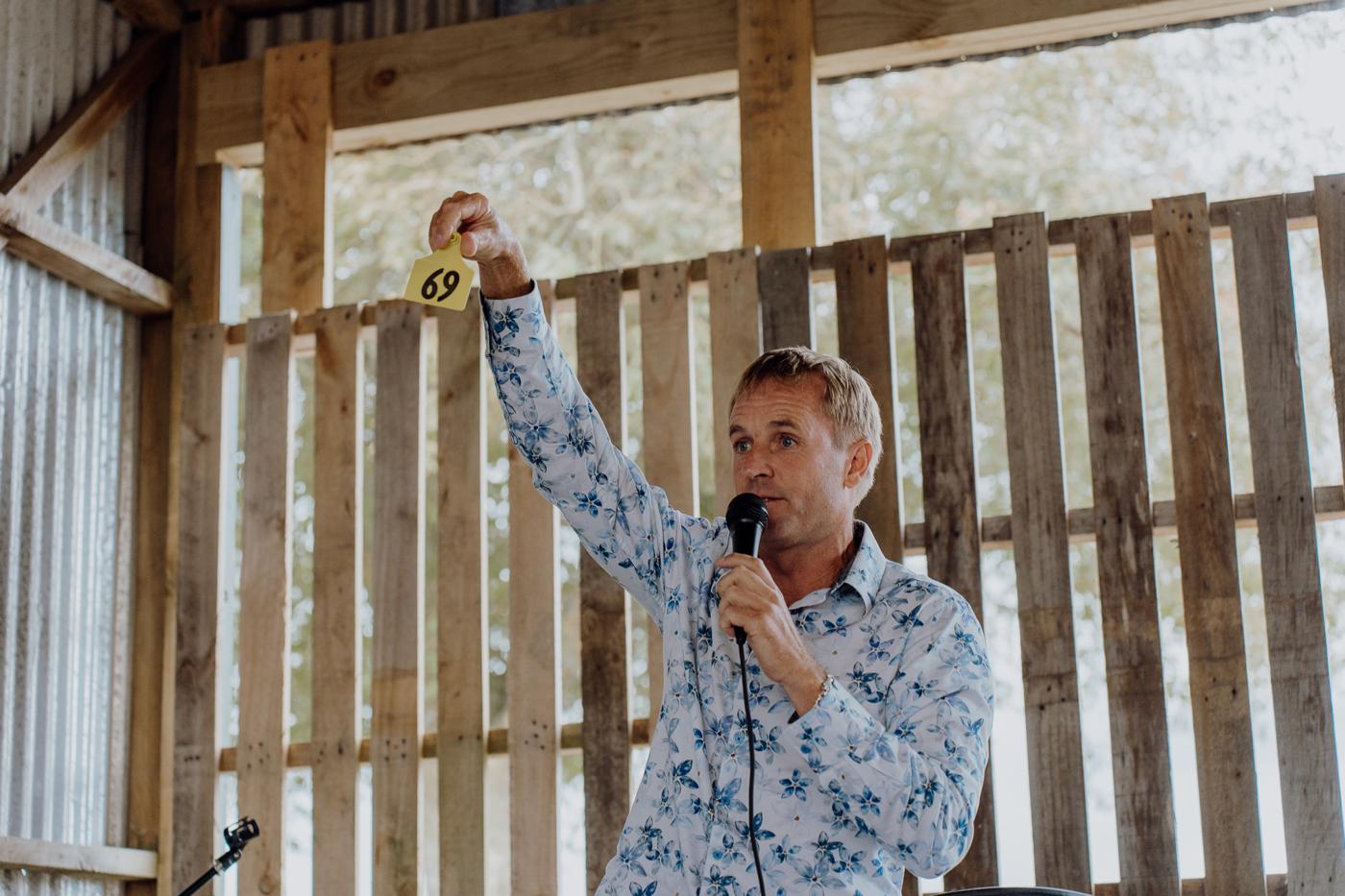 A guest giving a speech with a microphone in a woolshed