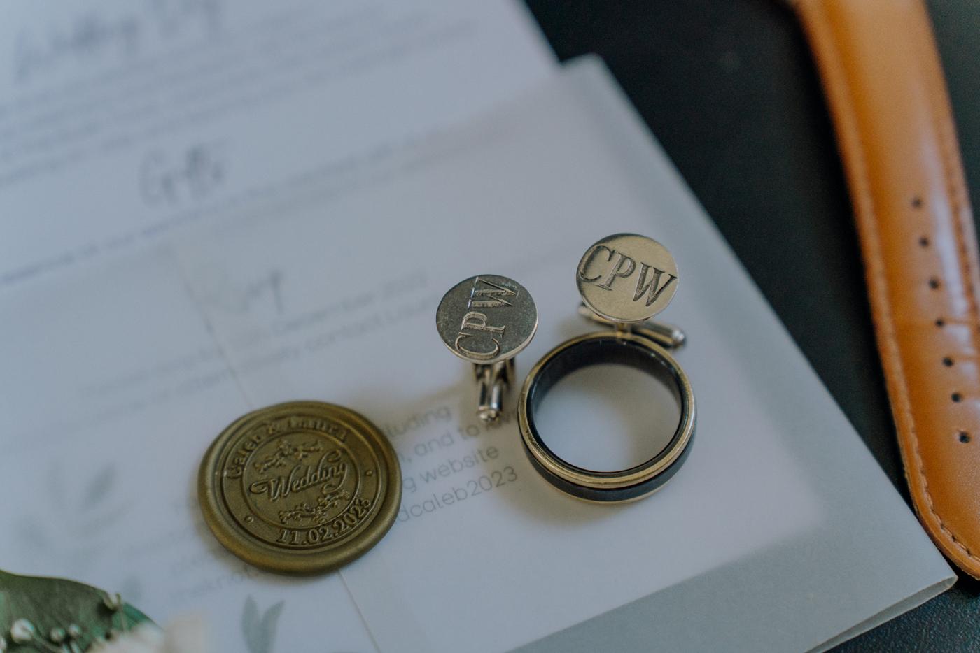 Wedding rings and an invitation on a table