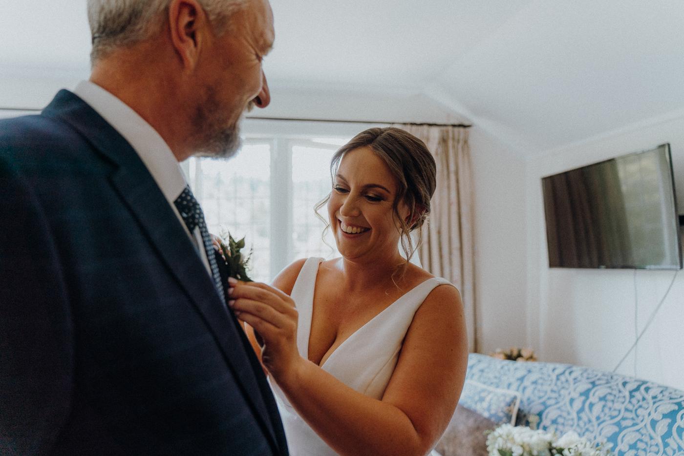 A father pinning a flower on his daughter's dress