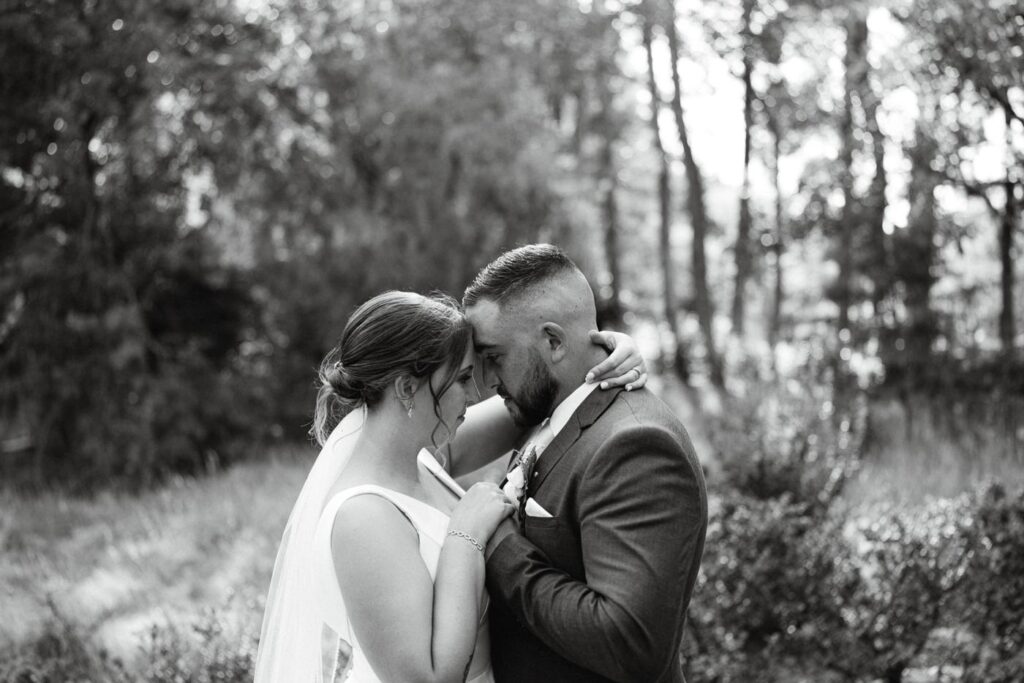 Laura and Caleb among the trees in black and white