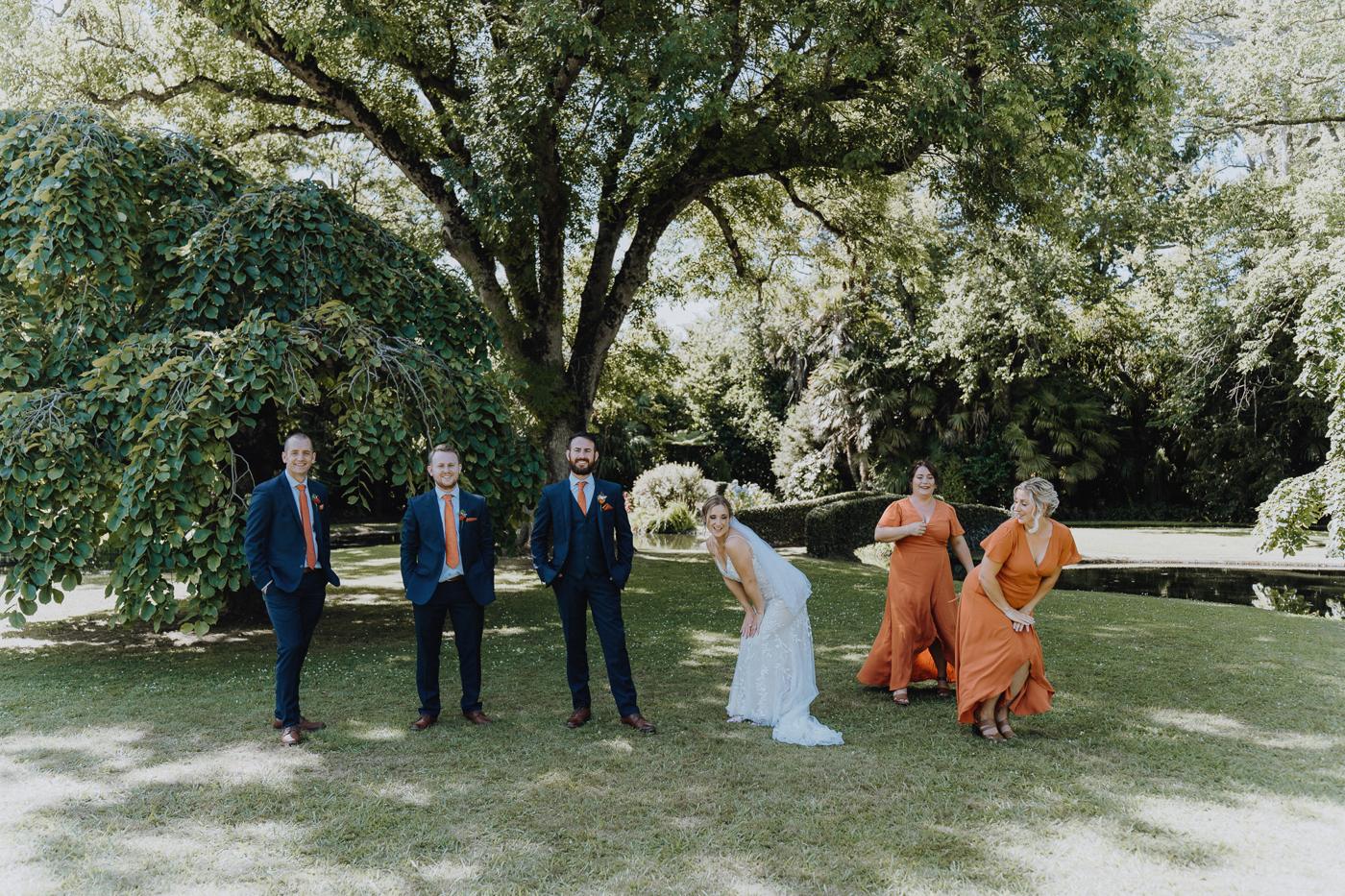 Groomsmen and bridesmaids playing together on the lawn