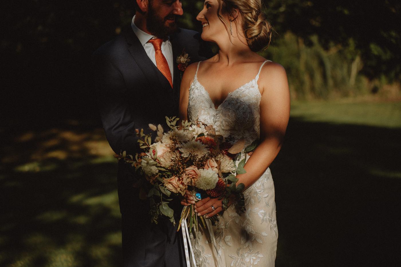 A couple in low golden light under the trees