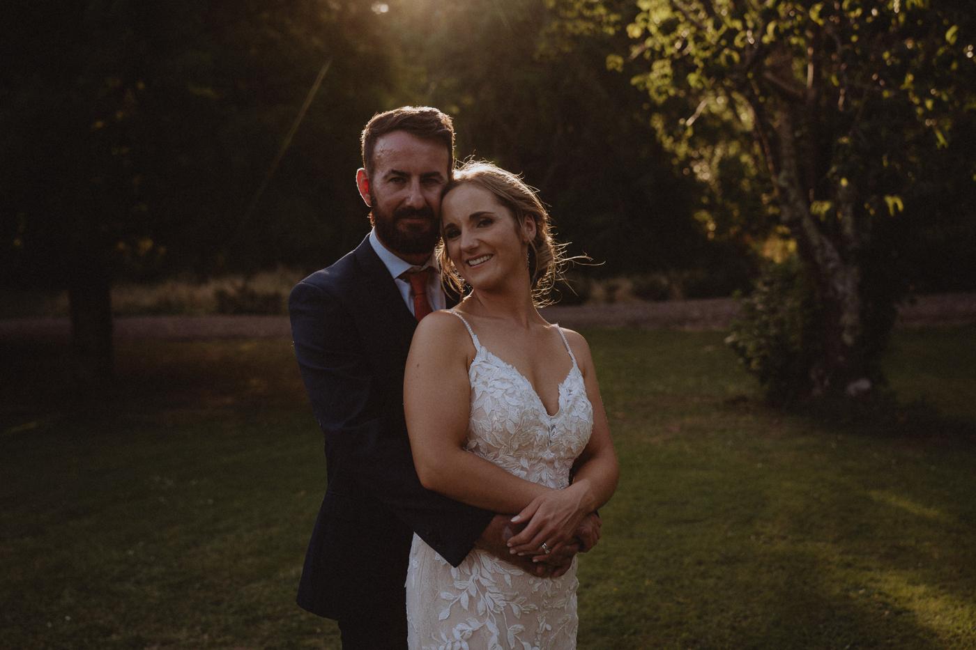 A couple in a warm embrace at golden hour