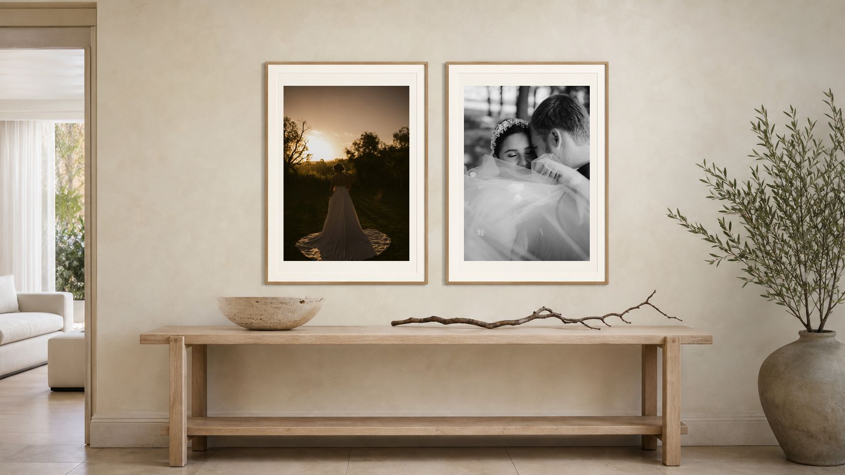 A hallway with two framed wedding prints hung above a timber console