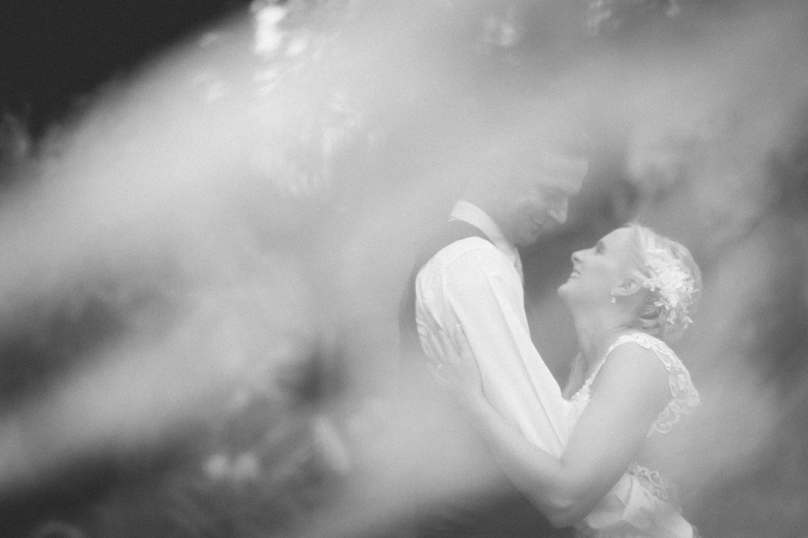 A couple embracing in soft black and white light